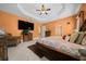 Well-lit main bedroom with ceiling fan, large TV, tiled floor, and beautifully coordinated furnishings at 3934 Se 110Th St, Belleview, FL 34420