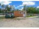 Exterior view of a small outbuilding with a golf cart parked outside on a sunny day at 3934 Se 110Th St, Belleview, FL 34420
