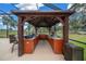 Covered outdoor kitchen featuring stainless steel appliances, granite countertops, and wood cabinets, perfect for outdoor entertaining at 3934 Se 110Th St, Belleview, FL 34420