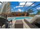 Backyard pool featuring an in-ground pool, hot tub, outdoor seating, and screened-in enclosure for year-round enjoyment at 3934 Se 110Th St, Belleview, FL 34420