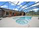 Inviting screened-in pool and spa with ample seating, perfect for relaxation and outdoor enjoyment at 3934 Se 110Th St, Belleview, FL 34420