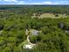 Aerial view of the property, surrounded by lush forest on a sunny day at 400 Se 90Th St, Ocala, FL 34480