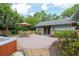 Spacious backyard patio featuring a dining set, hot tub, and well-maintained landscaping, perfect for outdoor relaxation and entertainment at 400 Se 90Th St, Ocala, FL 34480