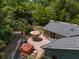 Private backyard featuring a brick patio with outdoor seating, hot tub, beautiful greenery and mature trees at 400 Se 90Th St, Ocala, FL 34480
