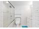 Clean bathroom with a tub and shower behind sliding glass doors at 400 Se 90Th St, Ocala, FL 34480
