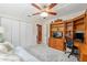 This bedroom features a ceiling fan, a blue couch, desk, and closet at 400 Se 90Th St, Ocala, FL 34480