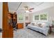 This bedroom has a ceiling fan, a blue couch, a desk, and an area rug at 400 Se 90Th St, Ocala, FL 34480