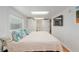 Bright bedroom featuring a bed, tv, and adjacent bathroom at 400 Se 90Th St, Ocala, FL 34480