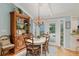 Charming dining area with elegant chandelier and view to the outdoor patio at 400 Se 90Th St, Ocala, FL 34480