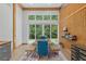 Bright dining area features a large window, wood paneling, a wooden table, and a colorful rug at 400 Se 90Th St, Ocala, FL 34480