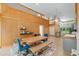 Open dining area with wood paneling, high ceilings, modern lighting, and a colorful rug at 400 Se 90Th St, Ocala, FL 34480