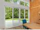 Dining area with large glass doors to the backyard and wood paneled wall at 400 Se 90Th St, Ocala, FL 34480