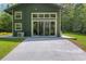 Back of the house featuring sliding glass doors and windows with gray trim and a concrete patio at 400 Se 90Th St, Ocala, FL 34480
