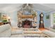 Close up of the stone fireplace with wood mantle and decorative iron screen at 400 Se 90Th St, Ocala, FL 34480