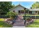 Charming home exterior with brick stairs and professional landscaping, inviting entrance showcasing curb appeal and natural beauty at 400 Se 90Th St, Ocala, FL 34480