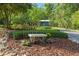 View of bench in the front yard landscaping at 400 Se 90Th St, Ocala, FL 34480