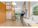 Open-concept kitchen features butcher block counters, wood beams, stainless appliances, and modern fixtures at 400 Se 90Th St, Ocala, FL 34480