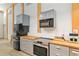 Modern kitchen features gray cabinets, butcher block countertops, stainless steel appliances, and subway tile backsplash at 400 Se 90Th St, Ocala, FL 34480