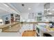 Bright kitchen featuring a breakfast bar, white cabinets and wooden floors at 400 Se 90Th St, Ocala, FL 34480