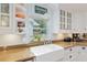 Well-lit kitchen features a farmhouse sink, updated appliances, and granite countertops at 400 Se 90Th St, Ocala, FL 34480