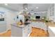 Bright kitchen with stainless steel island, stone countertops, and views into the living area at 400 Se 90Th St, Ocala, FL 34480
