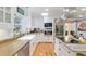 Modern kitchen with stainless steel appliances, farmhouse sink, and stone countertops at 400 Se 90Th St, Ocala, FL 34480