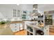 Well-equipped kitchen featuring a kitchen island, white cabinets, and stainless steel appliances at 400 Se 90Th St, Ocala, FL 34480