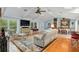 Bright living room featuring vaulted ceilings, wood floors, and an open floor plan at 400 Se 90Th St, Ocala, FL 34480