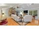 Cozy living room featuring a stone fireplace, vaulted ceilings and natural light at 400 Se 90Th St, Ocala, FL 34480