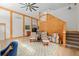 Inviting living room with wood beams, neutral decor, and staircase at 400 Se 90Th St, Ocala, FL 34480