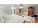 Airy main bedroom with wood floors, seating area, closet and French doors to the outside at 400 Se 90Th St, Ocala, FL 34480