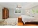 Main bedroom featuring a large window, white walls, and a wood floor at 400 Se 90Th St, Ocala, FL 34480