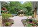 Charming outdoor patio area with dining set, umbrella, and lush landscaping, ideal for entertaining or enjoying peaceful moments at 400 Se 90Th St, Ocala, FL 34480