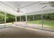 Screened in patio with ceiling fans and views of the wooded backyard at 400 Se 90Th St, Ocala, FL 34480
