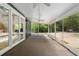 Screened in patio with ceiling fans and views of the wooded backyard at 400 Se 90Th St, Ocala, FL 34480
