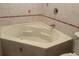 A corner bathtub is the focal point of this tiled bathroom at 439 Sw Shorewood Dr, Dunnellon, FL 34431