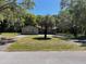 View of home framed by large trees, showing curb appeal and natural surroundings at 439 Sw Shorewood Dr, Dunnellon, FL 34431