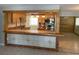 A cozy kitchen with wood cabinets, stainless steel appliances, and open breakfast bar at 439 Sw Shorewood Dr, Dunnellon, FL 34431