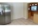 Kitchen area featuring stainless steel refrigerator, tile flooring, and an opening to the main kitchen at 439 Sw Shorewood Dr, Dunnellon, FL 34431