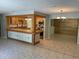An open kitchen with tile flooring and a bar separating the kitchen and living space at 439 Sw Shorewood Dr, Dunnellon, FL 34431