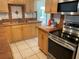 A kitchen featuring wood cabinets, stainless-steel appliances, and beautiful tile backsplash at 439 Sw Shorewood Dr, Dunnellon, FL 34431