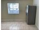 A kitchen with tile flooring and a window, featuring a stainless steel refrigerator at 439 Sw Shorewood Dr, Dunnellon, FL 34431
