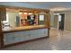 A charming kitchen features wood cabinets and an open layout with tiled breakfast bar at 439 Sw Shorewood Dr, Dunnellon, FL 34431