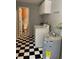 Laundry room with checkerboard flooring and a washer and dryer at 439 Sw Shorewood Dr, Dunnellon, FL 34431