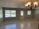 A sunlit living room boasts tile floors and an inviting chandelier at 439 Sw Shorewood Dr, Dunnellon, FL 34431