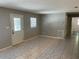 A bright, tiled living room offers a clean aesthetic and natural light through the front door and window at 439 Sw Shorewood Dr, Dunnellon, FL 34431