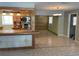 An open-concept living room with tile flooring, a light fixture, and wooden accent wall at 439 Sw Shorewood Dr, Dunnellon, FL 34431
