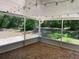 Screened-in patio with brick flooring, a white ceiling, and nature views at 439 Sw Shorewood Dr, Dunnellon, FL 34431