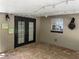 Covered patio with brick flooring, string lights, dark patio doors, and a window at 439 Sw Shorewood Dr, Dunnellon, FL 34431