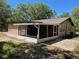 Relaxing screened porch offers outdoor living space and connects to a well-maintained yard at 439 Sw Shorewood Dr, Dunnellon, FL 34431
